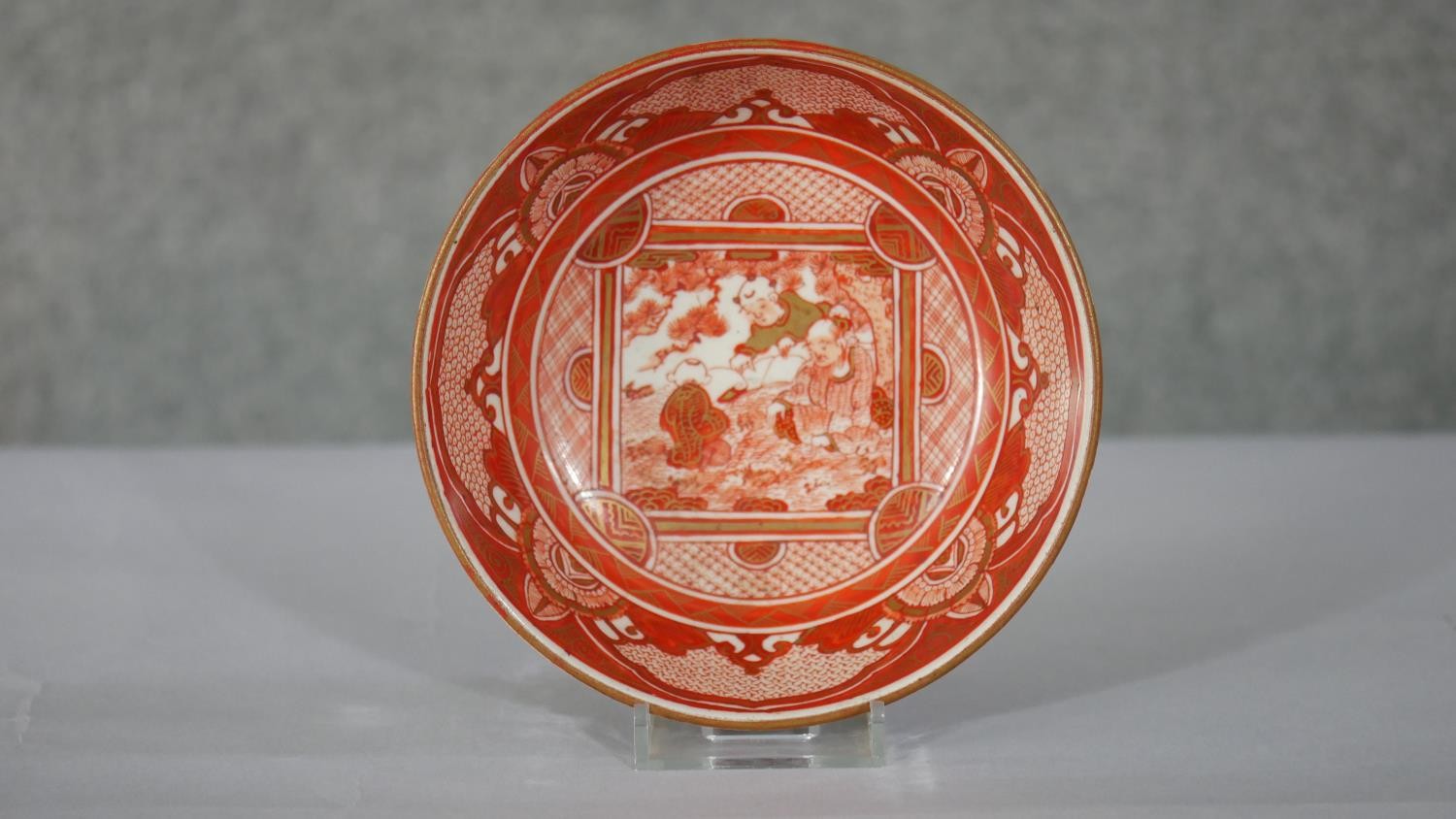 An 18th century Japanese red Kutani hand painted ceramic bowl. The centre decorated with figures