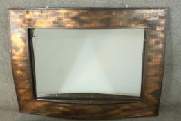 A contemporary copper framed mirror, of rectangular form, with a lattice design undulating frame.