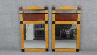 A pair of Biedermeier style birds eye maple mirrors, with an arched top flanked by gilded spheres,