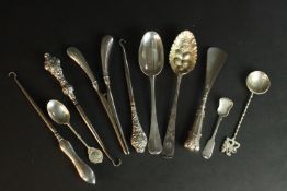 A collection of silver, including a berry spoon, glove stretchers, three boot hooks and various