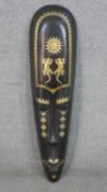 A large hardwood African tribal mask with brass detailing and salamander motifs. H.99 W.24cm