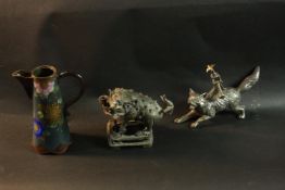 A Chinese bronze Foo dog with blue glass eyes, a Japanese cloisonné floral design jug and an
