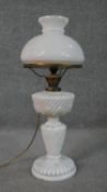 A Victorian moulded milk glass gadrooned design oil lamp, with milk glass shade, brass fittings