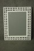 A white painted woven rattan framed mirror, with a rectangular mirror plate. H.53 W.43cm.