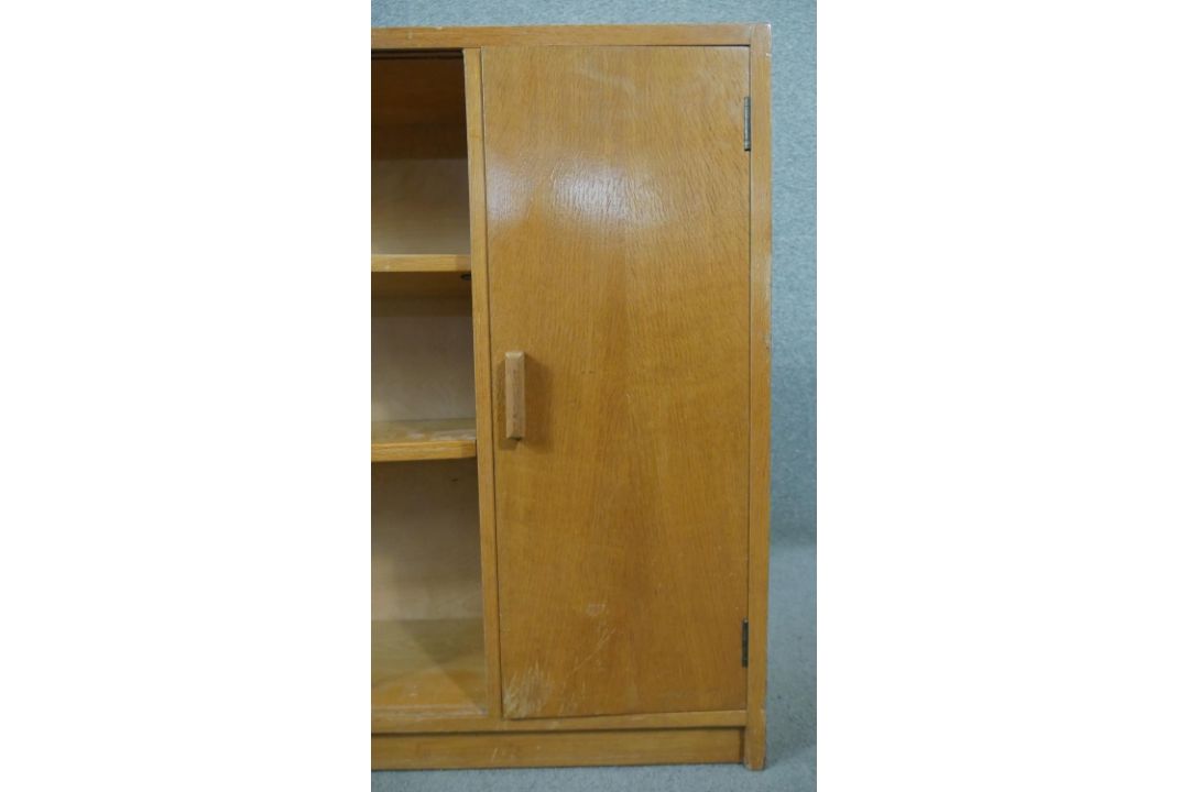 A 1960s light oak glazed Criterion bookcase, with two glass sliding doors enclosing shelves, one - Image 4 of 6
