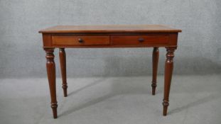 A Victorian mahogany two drawer side table, of rectangular form, on turned legs. H.75 W.107 D.53cm