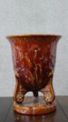 An Art Nouveau treacle glaze majolica planter with relief floral and foliate design. Impressed