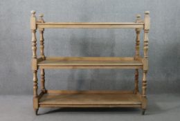 A Victorian pine whatnot, of rectangular form, the three shelves with gallery backs, on turned and