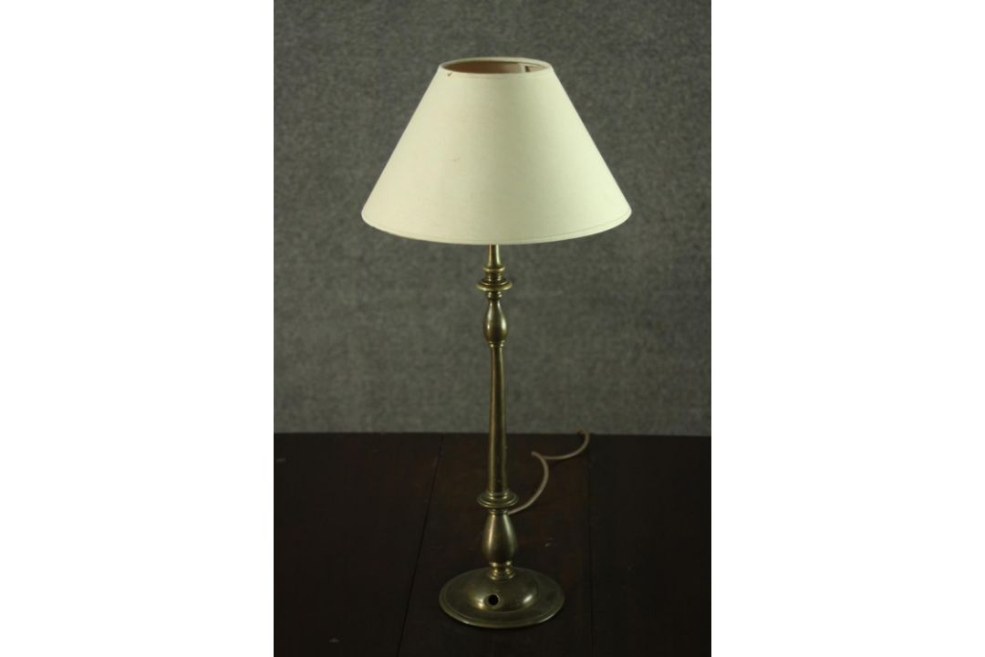 A turned brass table lamp, with an ivory coloured shade. H.56 W.25cm. - Image 1 of 4