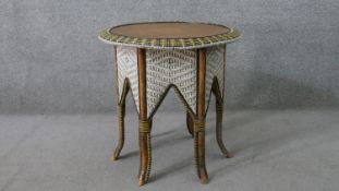 A Middle Eastern hexagonal occasional table, with a circular hardwood top, the sides with arched