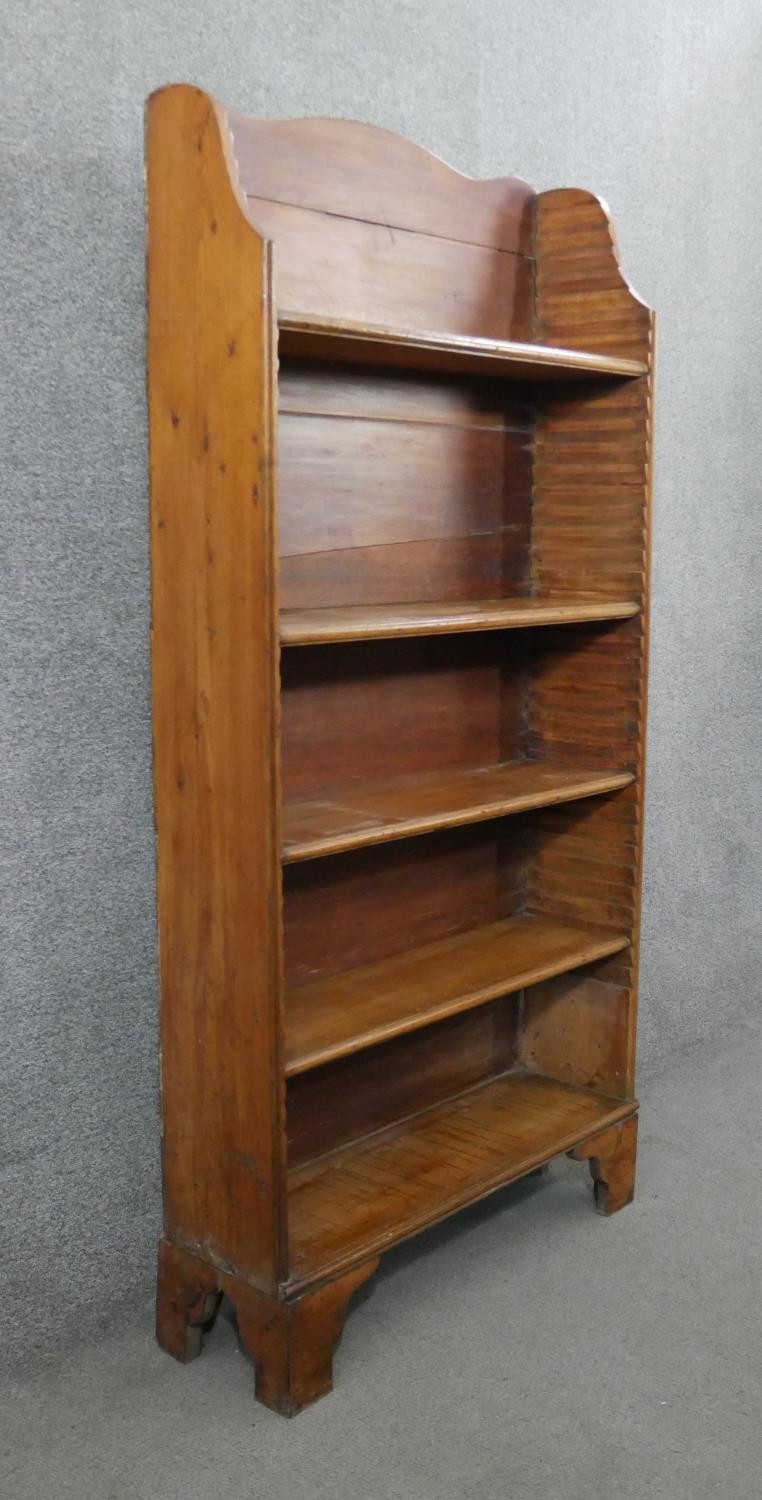 A George III pine waterfall style bookcase, with a shaped top, over four adjustable shelves, on - Image 4 of 8
