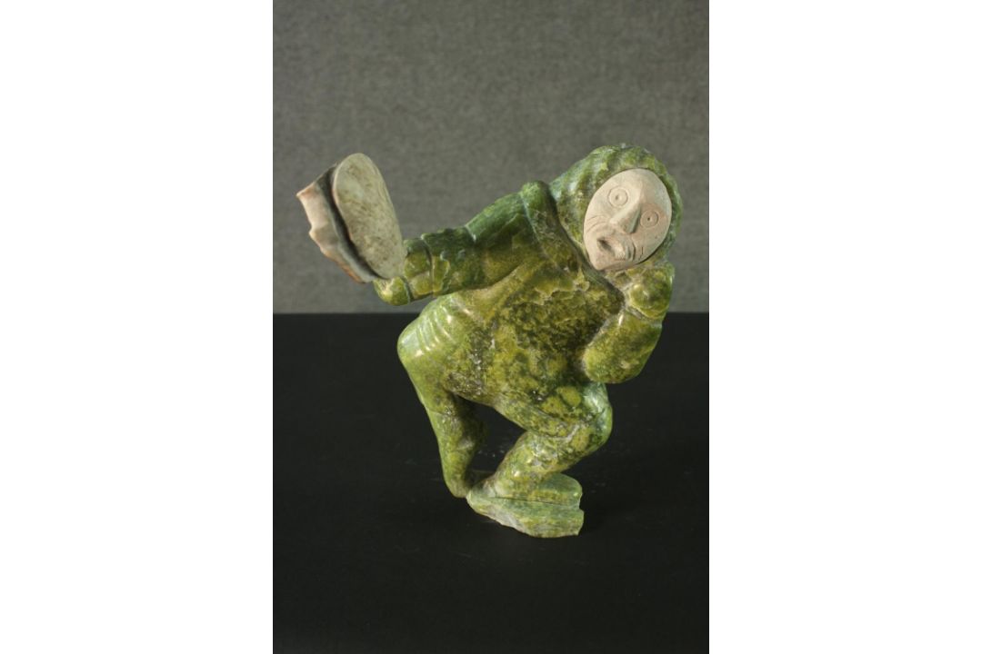 Aisa Amittu, Inuit, 1951, a carved green soapstone and granite drum dancer sculpture, with bone - Image 1 of 9
