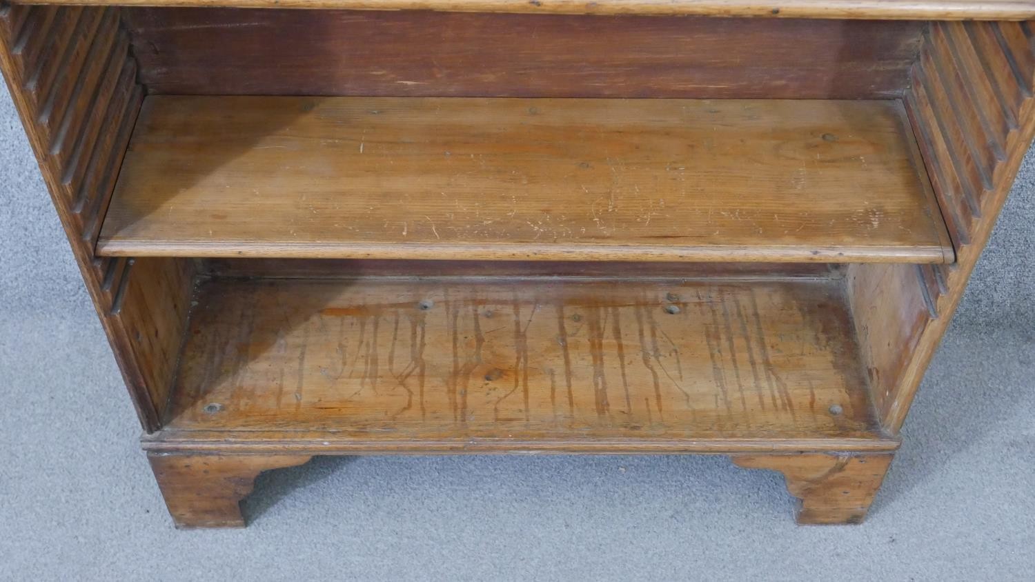 A George III pine waterfall style bookcase, with a shaped top, over four adjustable shelves, on - Image 7 of 8