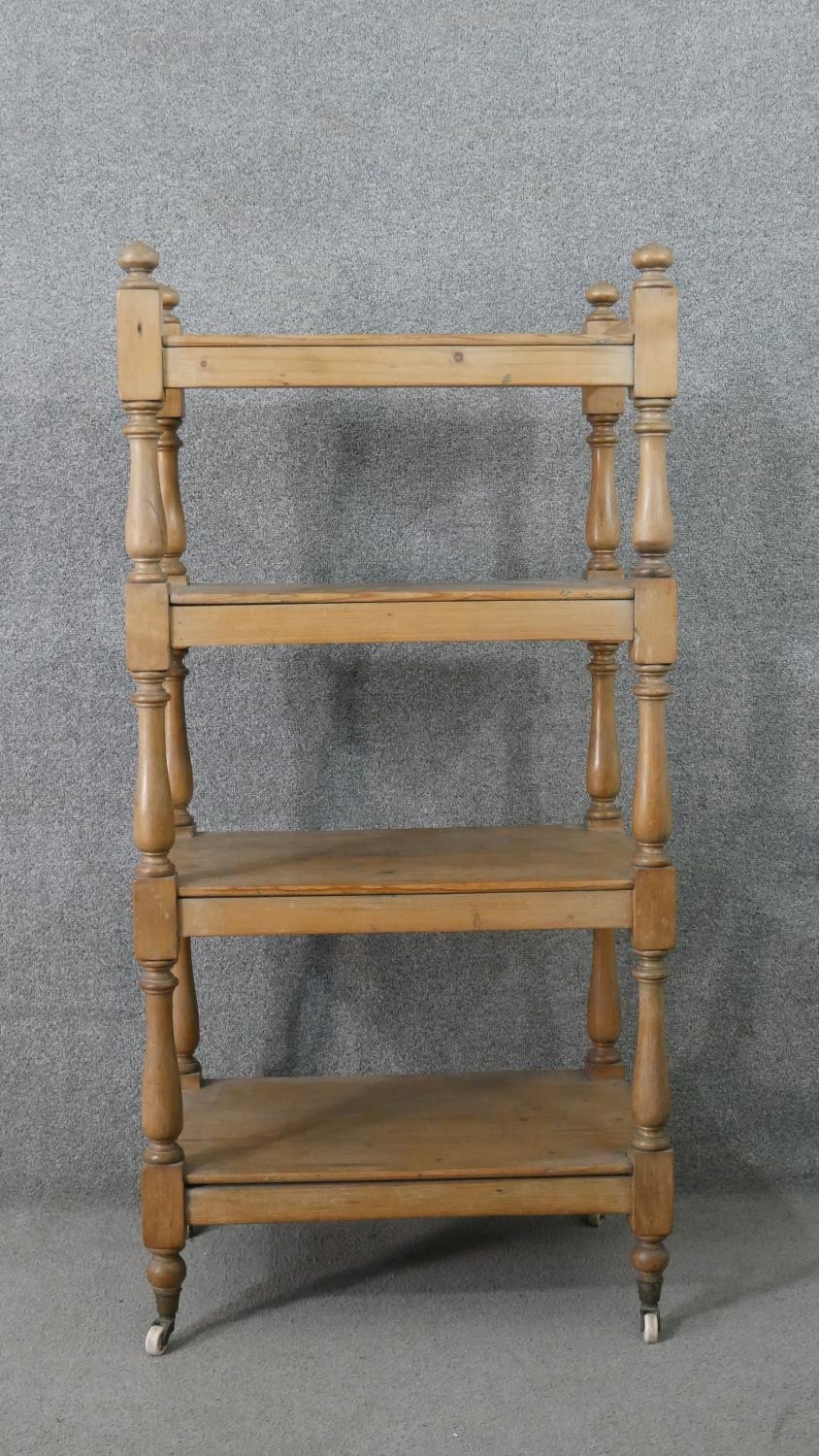 A Victorian pine whatnot, with four shelves joned by baluster turned stems. H.125 W.59 D.38cm