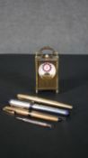 A Schild eight day miniature carriage clock with open escapement and enamel dial along with four