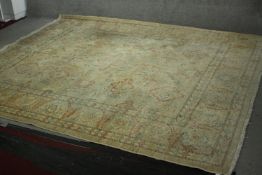 A Ziegler carpet with repeating stylised floral motifs on a biscuit ground. L.298 W.153cm.