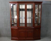A G-Plan mahogany display cabinet, with four glazed doors, enclosing glass shelves, with a