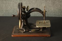 An American Willcox and Gibbs of New York hand sewing machine, with maker's label, on a mahogany