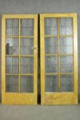 A pair of vintage simulated oak doors, lead set with textured glass panels, the reverse of one