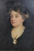 A framed giltwood and gesso framed oil on canvas of an elderly Victorian lady in black with cameo
