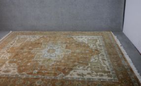 A hand made tan ground Indo-Heriz carpet. L.300 W.245cm
