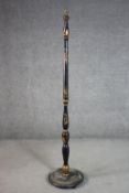 A circa 1920s Chinoiserie standard lamp, black lacquered and parcel gilt, with a turned stem on a