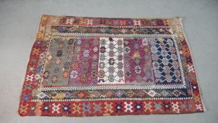 A flatweave Kelim rug with all over polychrome stylised design. L.180 W.120cm