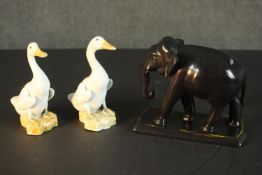 A pair of Chinese hand painted porcelain white ducks with orange feet and beaks along with an Art