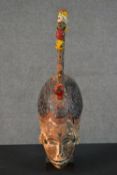 An early 20th century carved and painted African Tribal mask with coxcomb and colour ball