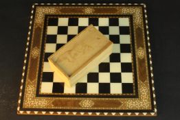 An Anglo-Indian inlaid bone and marquetry design chess board along with a boxwood chess set. L.40