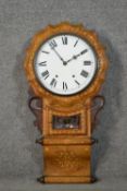 A circa 1900 marquetry inlaid walnut wall clock, with Roman numerals to the white enamelled dial,