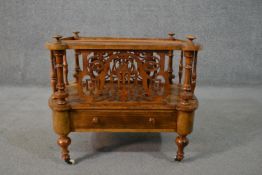 An early Victorian figured walnut Canterbury, with ornately pierced panels to the front and back,