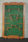 A 20th century Chinese hardwood wall mounted display cabinet, with a single glazed door, the
