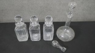 A collection of cut crystal and etched glass decanters, one with an engraved fern leaf design. H.