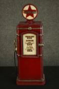A red painted CD rack in the form of a vintage style American gasoline pump. H.66 W.22 D.19cm.