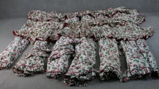 Three pairs of stylised pink floral design lined curtains with pelmet and tie backs. H.172 W.