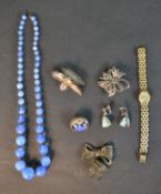 A collection of silver and costume jewellery including a blue opalescent glass necklace, a silver