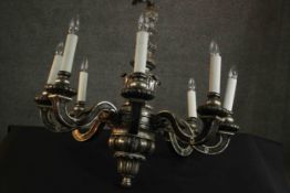 A silvered chandelier, the stem decorated with acanthus leaves with eight scrolling branches. H.80