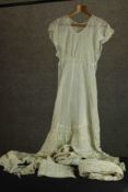 A collection of 19th century lace including dresses and smocks. (garments)