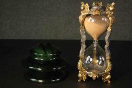 A gilt metal egg timer and a ceramic electricity conductor. H.28 Dia.12cm.