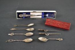 A collection of eight silver, silver plate and gilt metal commemorative teaspoons along with a boxed