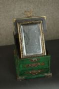 A contemporary Chinese travel dressing chest, green with painted gilt details, the lid opening to