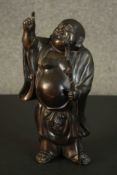 A Chinese bronze figure of Hotei pointing at the sky. H.32 W.16 D.14cm.