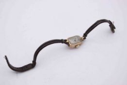 A 9ct yellow gold cased Art Deco ladies dress watch with a leather cord strap. (discolouration to