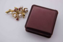 A 9 carat yellow gold floral spray brooch set with five cultured pearls and three round mixed cut