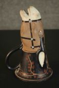 A Greek, late archaic period style painted ceramic handled drinking cup in the form of a bridled