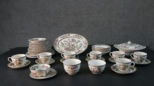 A Johnson Brothers Indian Tree pattern eight person part dinner service. Includes seven tea cups and