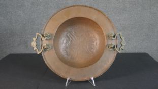 A 19th century hammered and engraved design copper brazier with brass handles. Diam.37cm