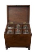 A GEORGIAN MAHOGAHY DECANTER BOX WITH 18TH CENTURY GLASS BOTTLES