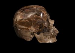 A CARVED PETRIFIED WOOD SKULL